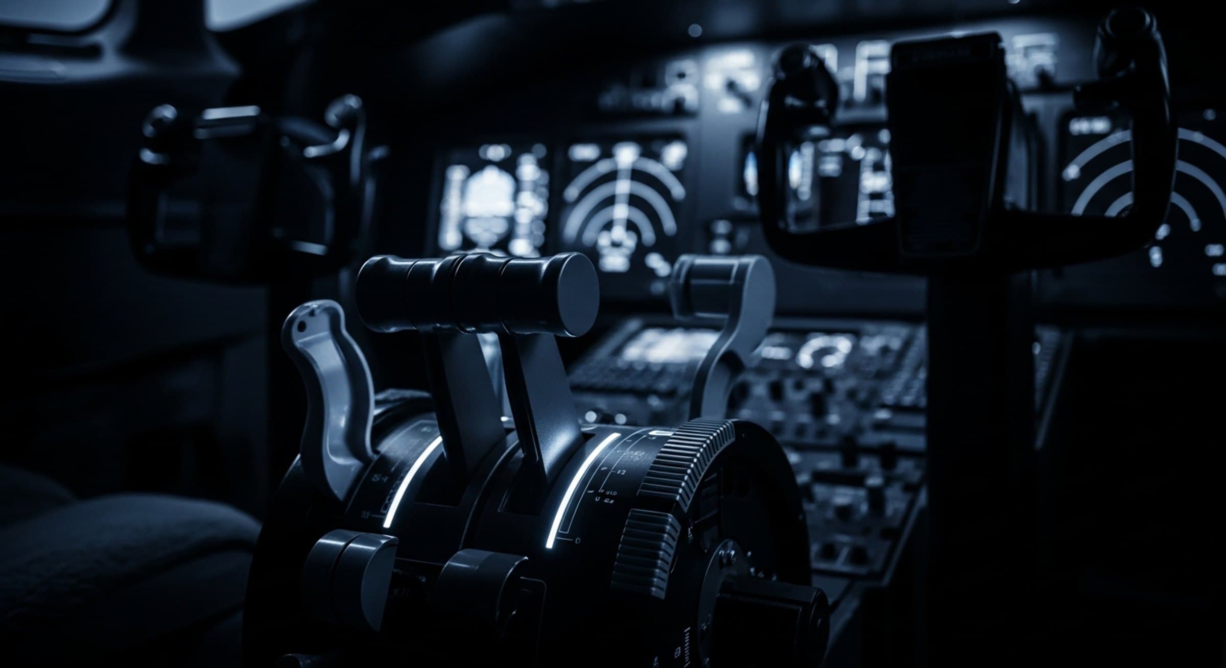 Throttle quadrant of a business jet in a dark cockpit